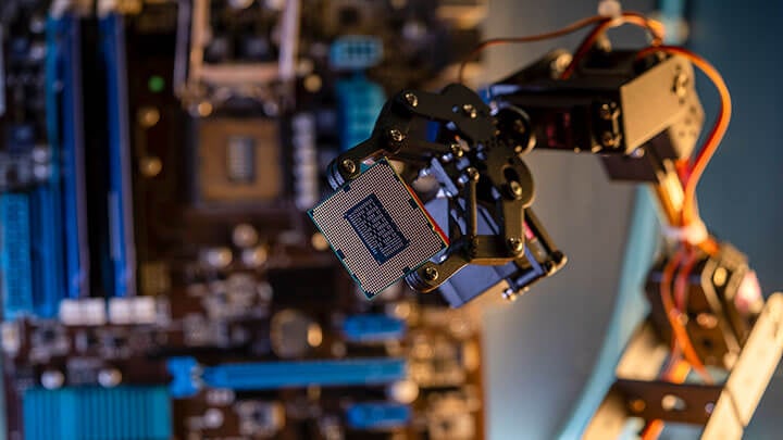 Robotic arm holding a silicon chip