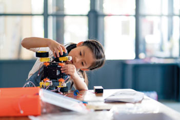 Child working on a robotic project