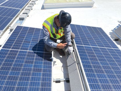 Man performing a check of solar panels